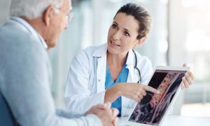 Doctor discussing Xray with older male patient